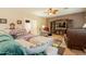 Inviting living room features comfortable seating, entertainment center and stylish ceiling fan at 2102 S Sabrina --, Mesa, AZ 85209