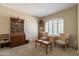 Inviting living room showcasing a cabinet, seating, and a large window with natural light at 2102 S Sabrina --, Mesa, AZ 85209