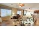 Living room featuring comfortable furniture, a ceiling fan, and large windows at 2102 S Sabrina --, Mesa, AZ 85209