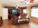 Spacious living room featuring tile floors, ceiling fans, and large windows for ample natural light at 2102 S Sabrina --, Mesa, AZ 85209