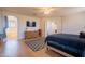 Bright main bedroom with a ceiling fan, a blue patterned rug, and wood-look floors at 2102 S Sabrina --, Mesa, AZ 85209
