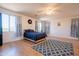 Bright main bedroom with a ceiling fan, a blue patterned rug, and wood-look floors at 2102 S Sabrina --, Mesa, AZ 85209