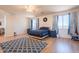 Bright main bedroom with a ceiling fan, a blue patterned rug, and wood-look floors at 2102 S Sabrina --, Mesa, AZ 85209
