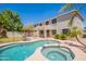 Backyard featuring a pool and spa surrounded by patio, landscaping, and mature trees at 2102 S Sabrina --, Mesa, AZ 85209