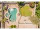 Aerial view of a backyard with a freeform pool, spa, lush landscaping, and grass lawn at 2102 S Sabrina --, Mesa, AZ 85209