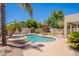 View of a sparkling pool and spa surrounded by lush landscaping and patio at 2102 S Sabrina --, Mesa, AZ 85209