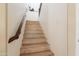 Wooden staircase with carpeted steps and dark-stained handrail at 2102 S Sabrina --, Mesa, AZ 85209