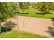 Aerial view of a sand volleyball court surrounded by green grass and mature trees at 2102 S Sabrina --, Mesa, AZ 85209