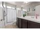 Well-lit bathroom with a shower-tub combo, white shower curtain, and dark wood vanity at 2614 S 120Th Ave, Avondale, AZ 85323