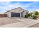 A well-kept single-story home with a two-car garage, complemented by desert landscaping and a concrete driveway at 2614 S 120Th Ave, Avondale, AZ 85323