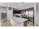 Kitchen features a granite island with sink, stainless steel appliances, and dark wood cabinets at 2614 S 120Th Ave, Avondale, AZ 85323