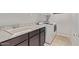 Practical laundry room with a utility sink, granite-style countertop, and modern appliances at 2614 S 120Th Ave, Avondale, AZ 85323