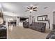 Open-concept living room flows to kitchen, tile floors, fan, neutral gray walls at 2614 S 120Th Ave, Avondale, AZ 85323