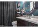 Stylish bathroom with vanity, ample storage, and decorative mirror and shelving at 30511 N 162Nd Way, Scottsdale, AZ 85262