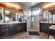 Modern bathroom featuring double sinks, stylish vanity, large glass shower, and warm lighting at 30511 N 162Nd Way, Scottsdale, AZ 85262