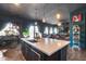 Open concept kitchen featuring an island with seating, pendant lighting, and black decor at 30511 N 162Nd Way, Scottsdale, AZ 85262