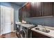 Convenient laundry room with stainless steel washer and dryer, and plenty of storage at 30511 N 162Nd Way, Scottsdale, AZ 85262