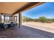 Covered patio with stone pavers, outdoor seating and landscaped backyard at 30511 N 162Nd Way, Scottsdale, AZ 85262