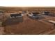 Aerial view showing multiple new homes situated in a vast desert landscape with mountains on the horizon at 34449 N Elk Run Rd, San Tan Valley, AZ 85143
