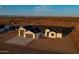 Aerial view displaying home's layout with garages, a covered patio and a desert setting, set against mountain backdrop at 34449 N Elk Run Rd, San Tan Valley, AZ 85143
