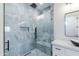 Contemporary bathroom featuring a walk-in shower with blue tile, a dark shower fixture, and white cabinetry at 34449 N Elk Run Rd, San Tan Valley, AZ 85143