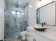 Elegant bathroom featuring a walk-in shower with blue tile, a dark shower fixture, and toilet at 34449 N Elk Run Rd, San Tan Valley, AZ 85143