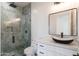 Stylish bathroom with dual vessel sinks, modern fixtures, a walk-in shower with blue tile, and a toilet at 34449 N Elk Run Rd, San Tan Valley, AZ 85143
