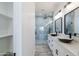 Modern bathroom with dual vessel sinks, a walk-in shower with blue tile, and neutral walls at 34449 N Elk Run Rd, San Tan Valley, AZ 85143