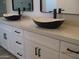 Bathroom featuring dual vessel sinks, white cabinets, light countertop, and matte black hardware at 34449 N Elk Run Rd, San Tan Valley, AZ 85143