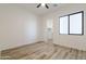 Bedroom features hardwood floors, a modern ceiling fan and a window with natural light at 34449 N Elk Run Rd, San Tan Valley, AZ 85143