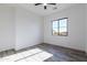 Bright bedroom with wood-look floors, a modern ceiling fan, and a window with natural light at 34449 N Elk Run Rd, San Tan Valley, AZ 85143