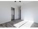Bright bedroom features a ceiling fan, wood-look floors, and closet with sliding doors at 34449 N Elk Run Rd, San Tan Valley, AZ 85143