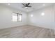 Bright bedroom with wood-look tile floors, a ceiling fan, recessed lighting, and a large window at 34449 N Elk Run Rd, San Tan Valley, AZ 85143