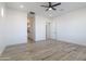Large bedroom with wood-look tile floors, a ceiling fan, recessed lights, and access to a closet at 34449 N Elk Run Rd, San Tan Valley, AZ 85143