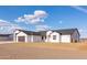 Modern home exterior with multi-car garage and desert landscaping showcases clean lines and simple elegance at 34449 N Elk Run Rd, San Tan Valley, AZ 85143