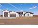 Stylish exterior showcases a modern, white-colored home with a spacious driveway and ample garage space at 34449 N Elk Run Rd, San Tan Valley, AZ 85143
