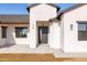 Close-up of the modern front entrance with a stylish door, contemporary lighting, and beautiful white walls at 34449 N Elk Run Rd, San Tan Valley, AZ 85143