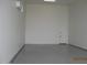 Spacious garage with sealed concrete floors, bright lighting, and mini split AC at 34449 N Elk Run Rd, San Tan Valley, AZ 85143