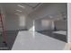 Bright, spacious garage with polished floor, offering ample room for parking and storage at 34449 N Elk Run Rd, San Tan Valley, AZ 85143