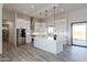 Modern kitchen with white cabinets, quartz countertops, stainless steel appliances, and a large island at 34449 N Elk Run Rd, San Tan Valley, AZ 85143