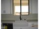 The kitchen features updated stainless appliances and a modern farmhouse sink at 34449 N Elk Run Rd, San Tan Valley, AZ 85143