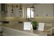 White cabinets, stainless appliances, and a large center island define the kitchen at 34449 N Elk Run Rd, San Tan Valley, AZ 85143