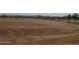 Wide open plot of land enclosed by a fence, showing cleared dirt with tire tracks at 34449 N Elk Run Rd, San Tan Valley, AZ 85143