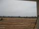 View of expansive land with perimeter fence and sparse vegetation at 34449 N Elk Run Rd, San Tan Valley, AZ 85143