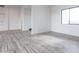 Bright open living space featuring wood-look tile flooring and natural light at 34449 N Elk Run Rd, San Tan Valley, AZ 85143