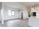 Living room showing a barn door, connecting to the kitchen with a quartz counter and stainless refrigerator at 34449 N Elk Run Rd, San Tan Valley, AZ 85143