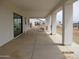 Long covered patio with concrete floor and pillars, offering outdoor living space at 34449 N Elk Run Rd, San Tan Valley, AZ 85143