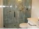 Modern bathroom featuring a glass-enclosed shower with stylish marble tile and sleek, dark fixtures at 34449 N Elk Run Rd, San Tan Valley, AZ 85143