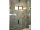 Modern shower with glass door, grey marble-style tile surround, and matte black hardware at 34449 N Elk Run Rd, San Tan Valley, AZ 85143