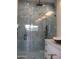 Stylish shower with grey marble-style tile, glass door, and matte black fixtures at 34449 N Elk Run Rd, San Tan Valley, AZ 85143